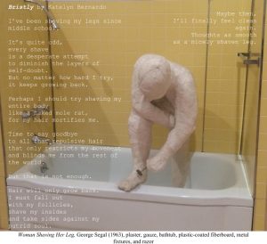 Man covered in shaving cream shaving his leg in a porcelain bathtub. The walls are yellow.