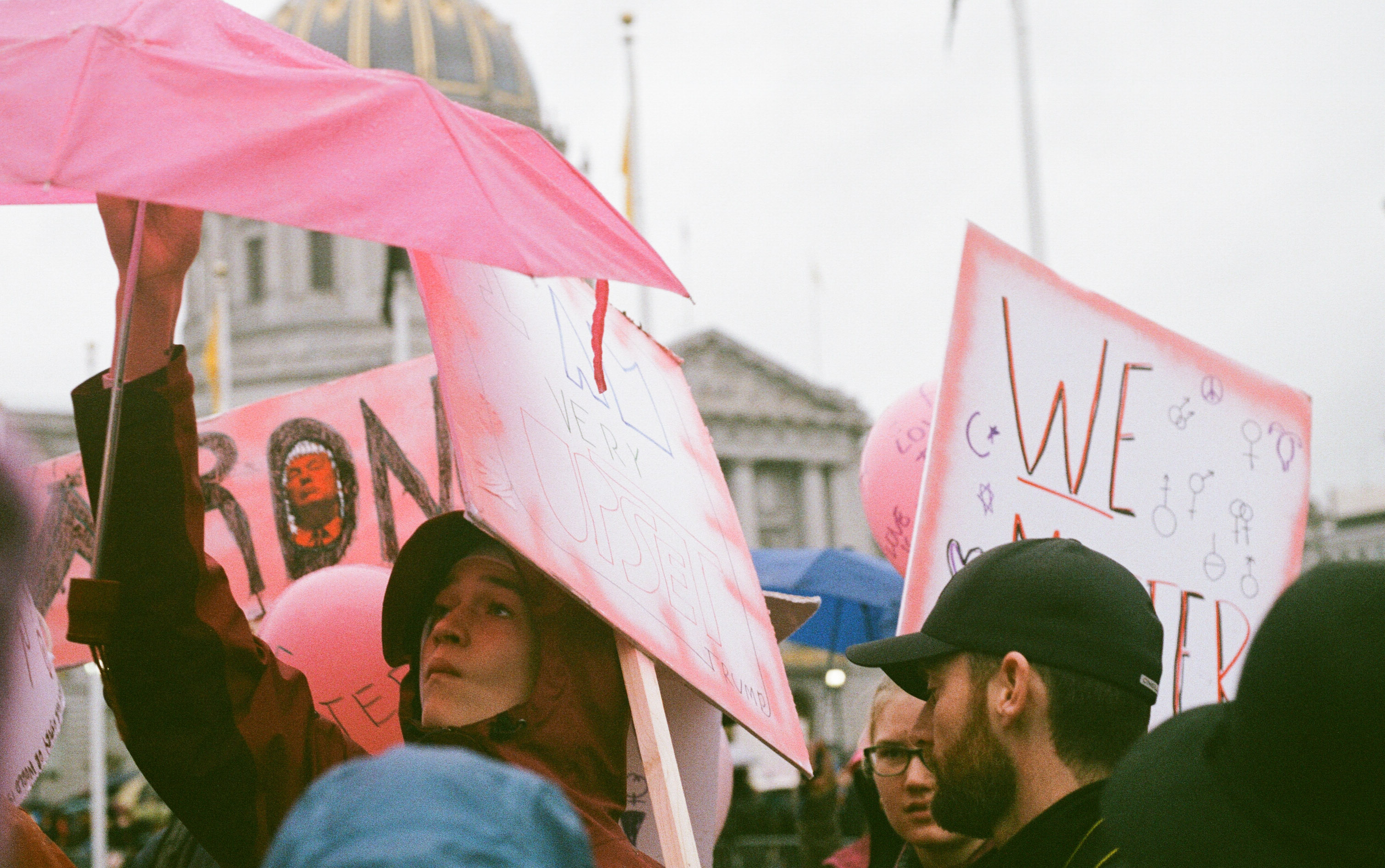 Protestors take cover from the rain at the first Women's March.