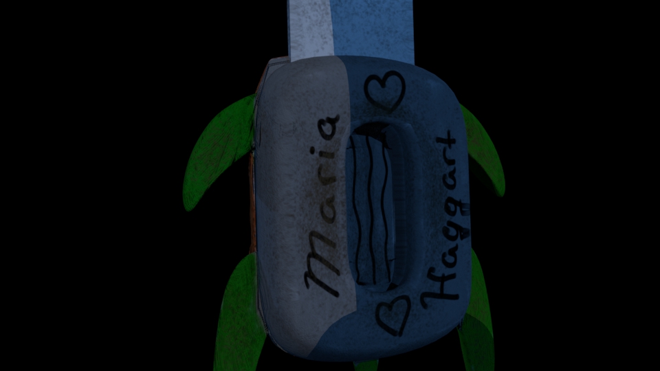A close up of the cushion. It has my name on it and hearts on the top and bottom of it, with squiggles in the little indent. It is dirty to show use. 