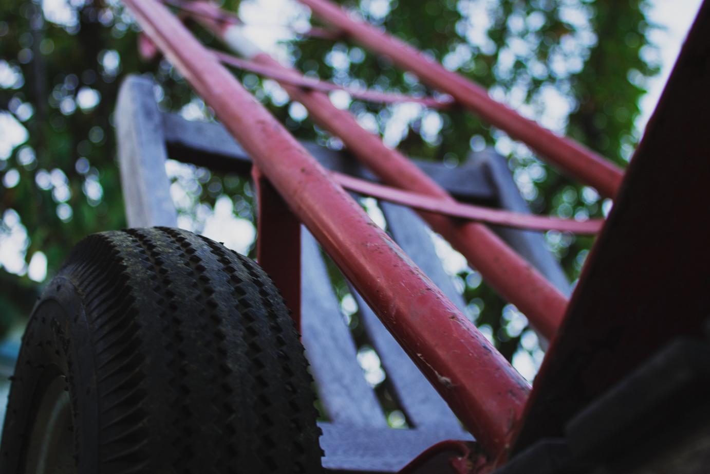 The image depicts a close-up shot of the wheel of a trolley from beneath.