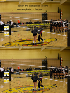 Two volleyball refs talking at at a volleyball net