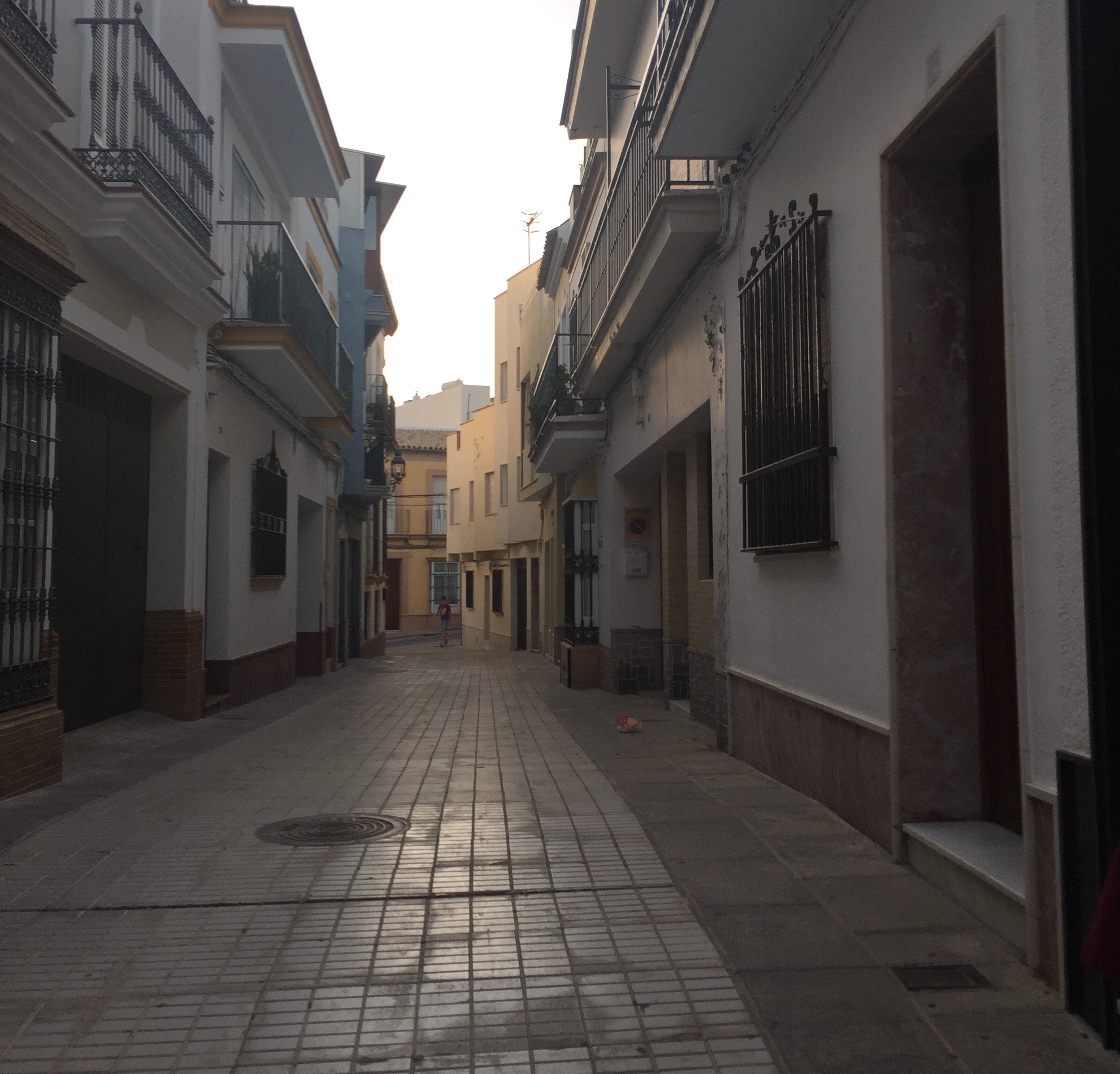 A picture of a street with buildings on either side leading off to the distance.