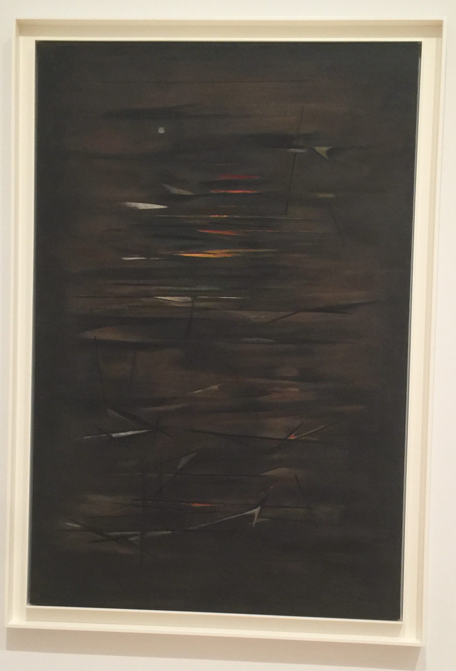 A painting with a dark image of what looks like ocean, littered with broken ships