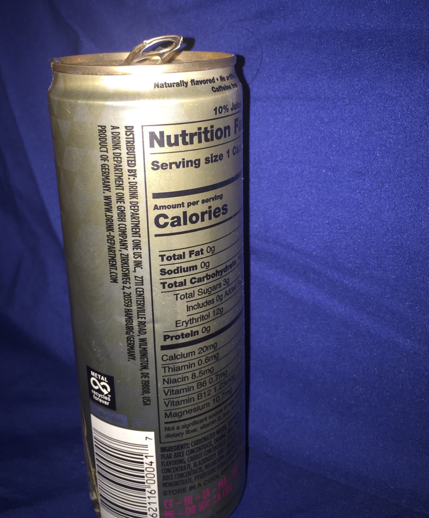 A photograph of a soda can in darkness, with a bright light illuminating it.