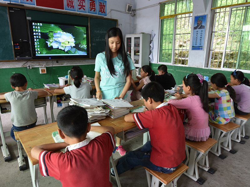 Youth Group Volunteer May (center) Teaching In A Renovated Classroom