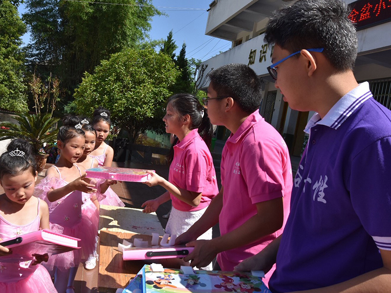Youth Group Volunteers Handing Out Learning Materials