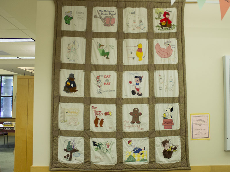 A quilt of book characters made by Mountain View Public Library patrons in the 1980s.