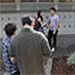 The film crew, extras, and actors, Stefano Scotti and Shayda Dehnow, on set.