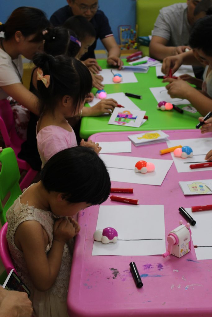 This photo shows little kids playing with toys that involve coding.