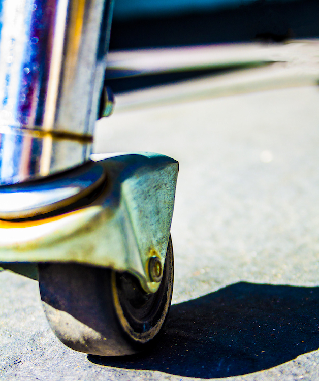 A close of photo of a chair's wheel.