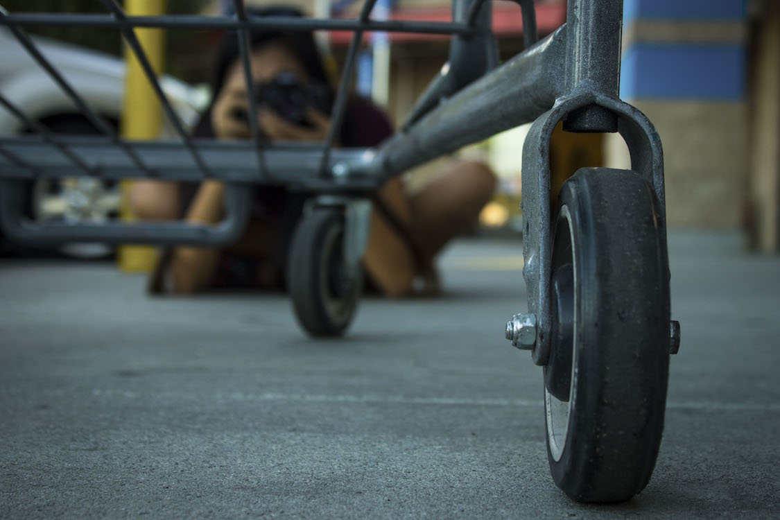 This is a photo of a shopping cart with a photographer in the background