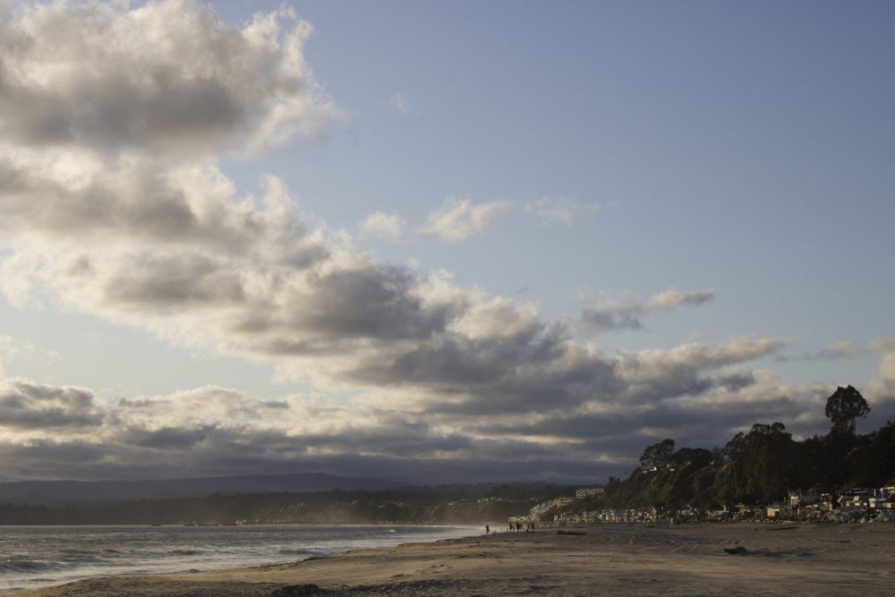 A image of the beach with dramatic clouds in the sky.
