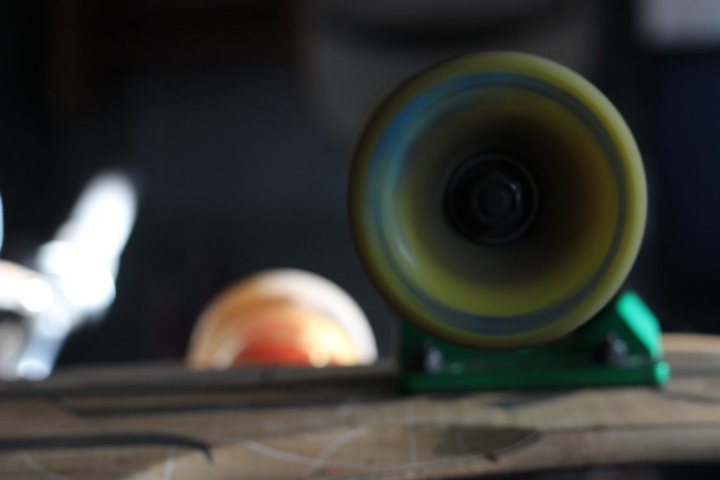 Photo of the rules of thirds that shows motion. The photo shows a longboard wheel spinning. 