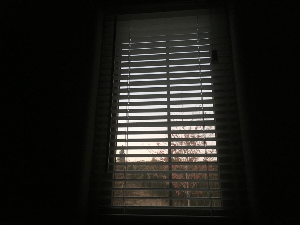 Image of a window in a dark room.