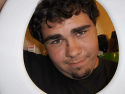 My boyfriend holding a toilet seat around his face