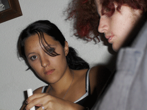 Venesa looking suprised, half hidden behind her boyfriends 'fro