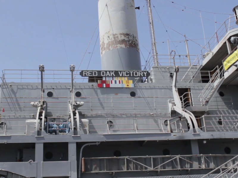 The name of the Red Oak Victory is displayed on the side of the ship.