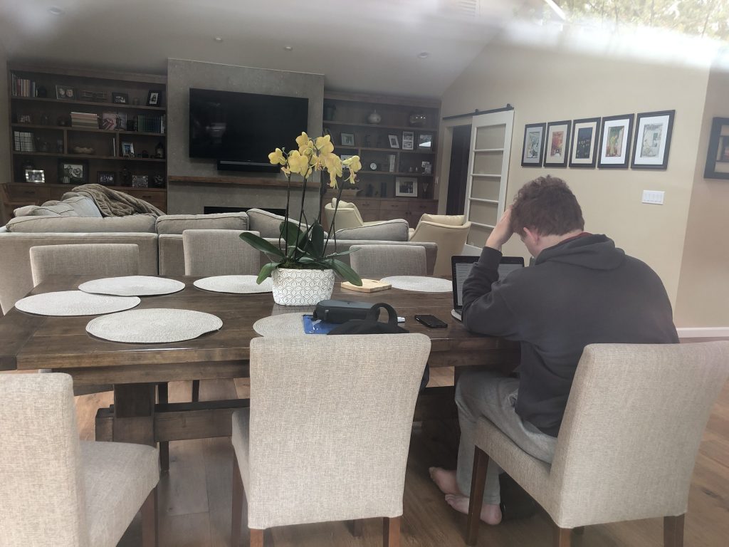 The image shows a person studying at a table 